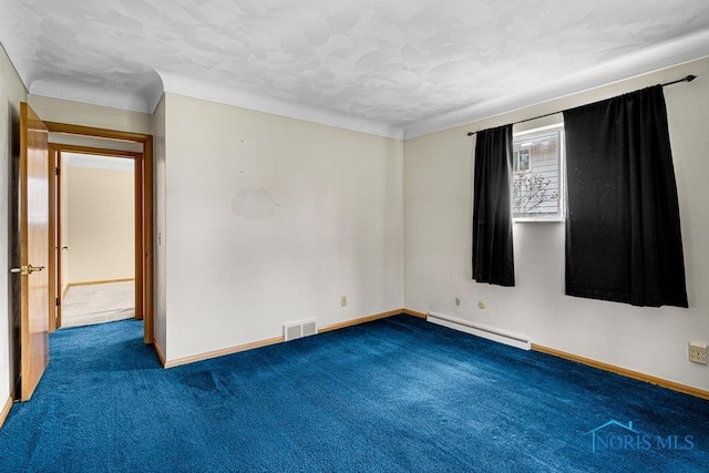 spare room featuring baseboard heating and carpet floors