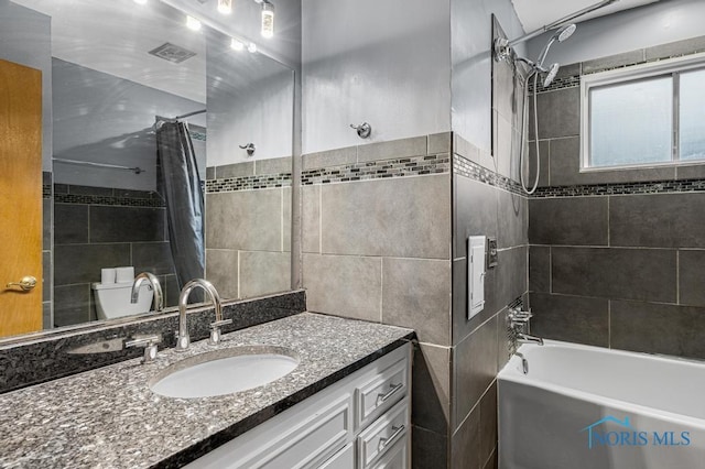 full bathroom with vanity, toilet, and shower / bath combo with shower curtain