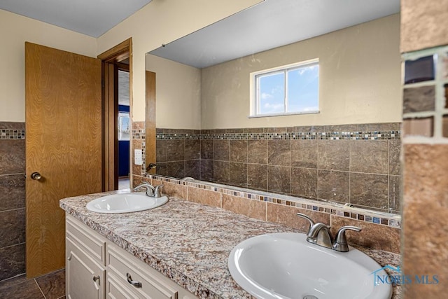 bathroom with vanity and tile walls