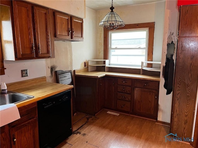 kitchen with light hardwood / wood-style flooring, an inviting chandelier, pendant lighting, and black dishwasher