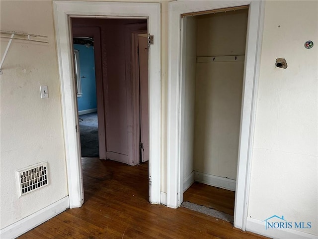 corridor with dark hardwood / wood-style floors