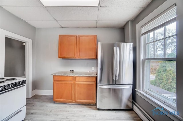 kitchen featuring white electric range, baseboard heating, light hardwood / wood-style flooring, stainless steel fridge, and a paneled ceiling