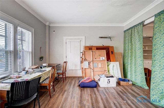 miscellaneous room featuring hardwood / wood-style floors and crown molding