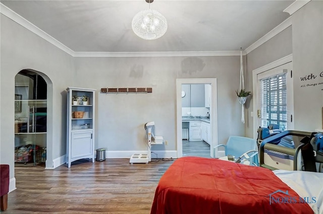 bedroom featuring ensuite bathroom, crown molding, and dark wood-type flooring