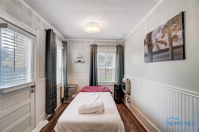 bedroom with dark hardwood / wood-style flooring and ornamental molding