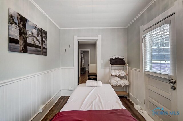 bedroom with crown molding and dark wood-type flooring