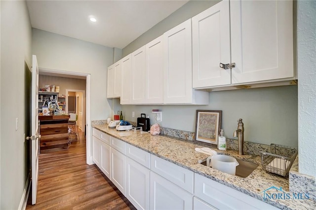 kitchen with sink, white cabinetry, and dark wood-type flooring