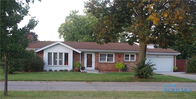 ranch-style home with a garage and a front lawn