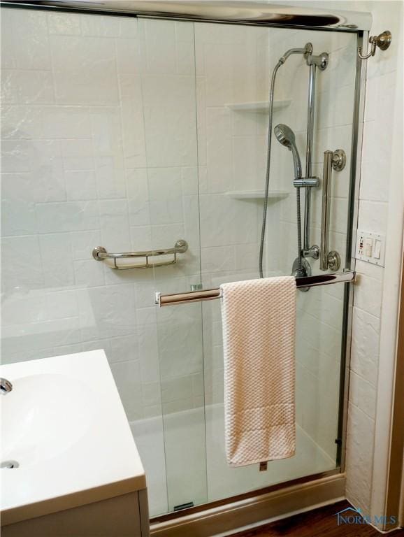 bathroom featuring vanity and an enclosed shower