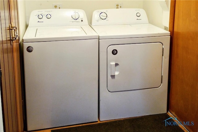 clothes washing area with washing machine and dryer