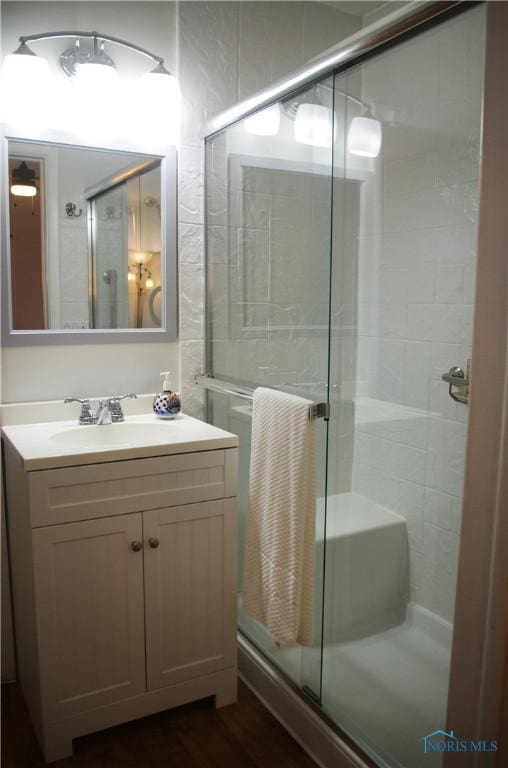 bathroom featuring vanity and an enclosed shower