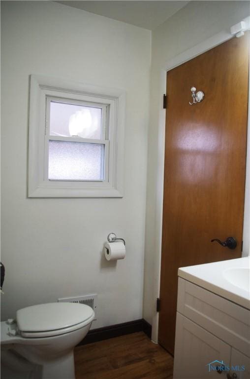 bathroom with vanity, hardwood / wood-style flooring, and toilet