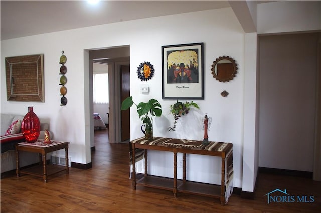 hall with dark hardwood / wood-style flooring