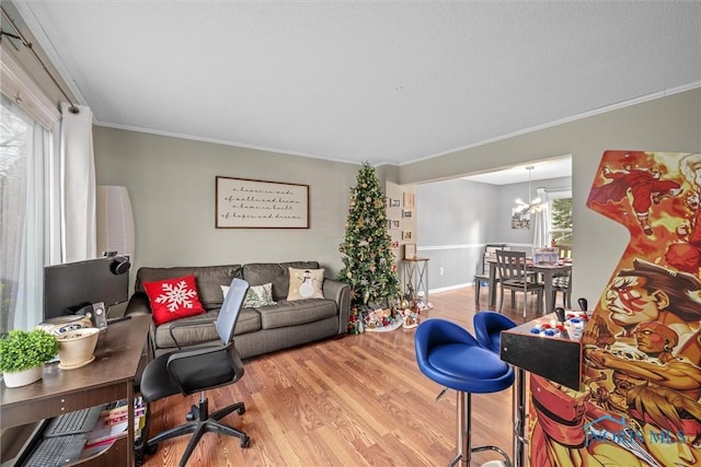 living room featuring a chandelier, plenty of natural light, wood-type flooring, and ornamental molding