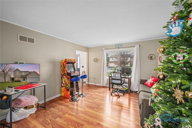 interior space featuring light hardwood / wood-style floors and ornamental molding