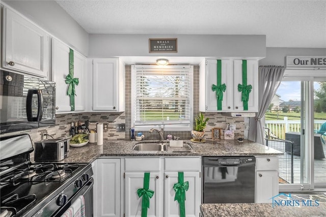 kitchen with black appliances, white cabinets, sink, and tasteful backsplash