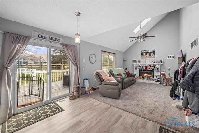 living room featuring hardwood / wood-style floors, ceiling fan, and a wealth of natural light