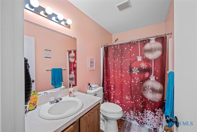 bathroom with curtained shower, hardwood / wood-style floors, vanity, and toilet