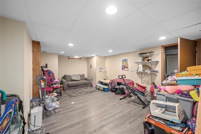 rec room with a drop ceiling and wood-type flooring