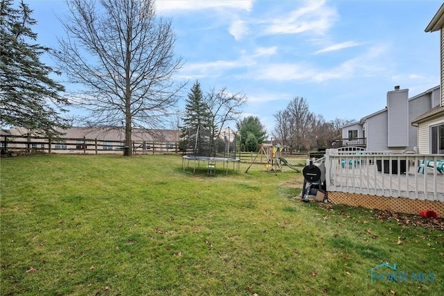 view of yard featuring a playground and a trampoline