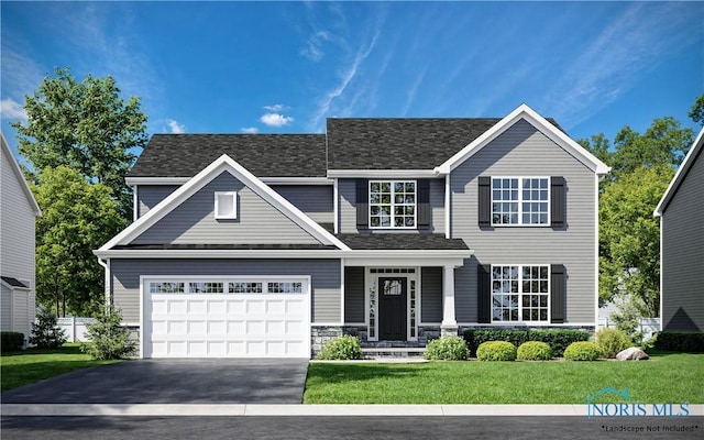 view of front facade with a garage and a front lawn