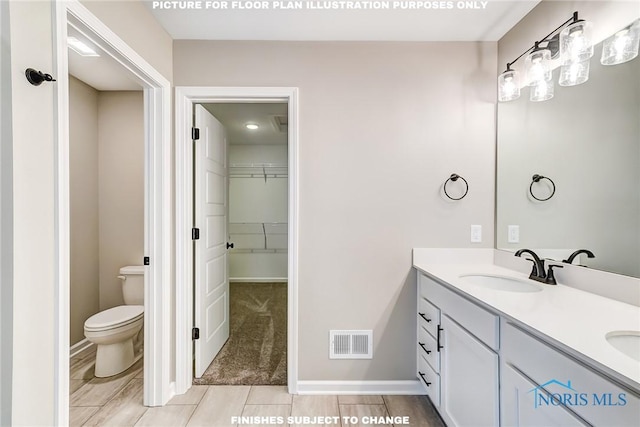 bathroom featuring vanity and toilet