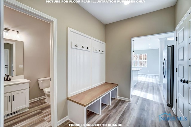 mudroom with light wood-type flooring and sink