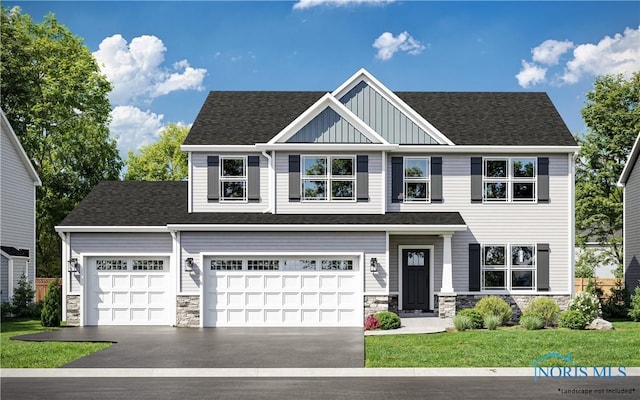 view of front of home with a garage and a front lawn