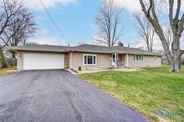 ranch-style home with covered porch, a garage, and a front yard