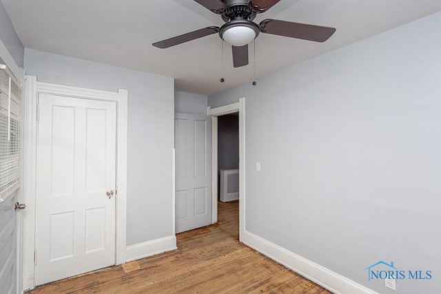 unfurnished bedroom featuring a closet, ceiling fan, and light hardwood / wood-style flooring