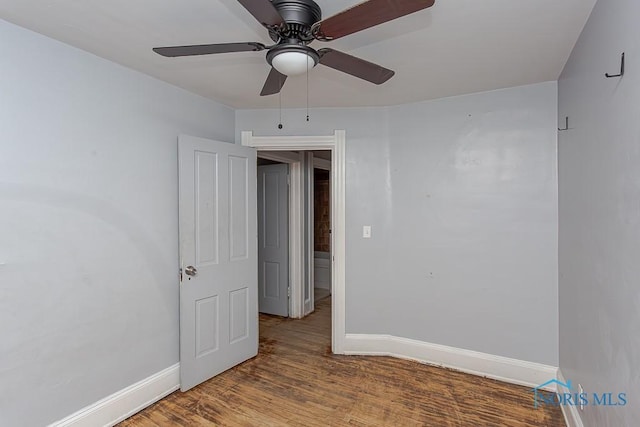 empty room featuring hardwood / wood-style floors and ceiling fan