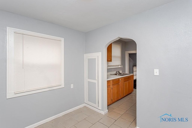 kitchen featuring sink and light tile patterned flooring