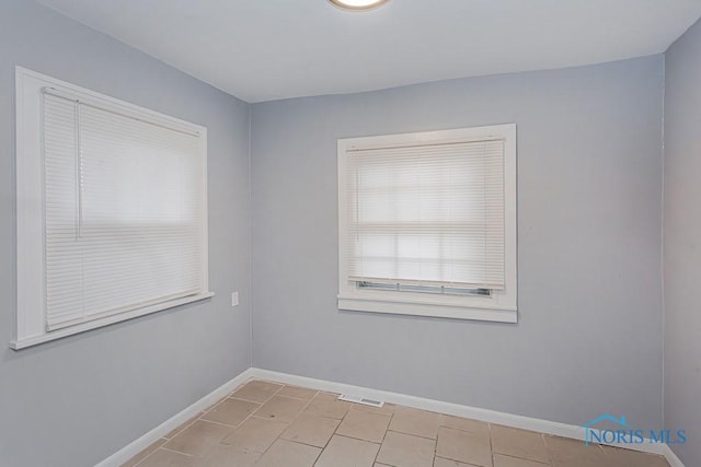 spare room with light tile patterned floors