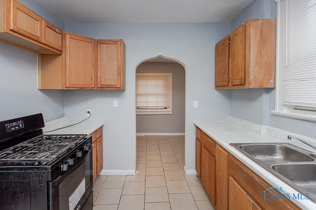 kitchen with light tile patterned flooring, sink, and black range with gas cooktop