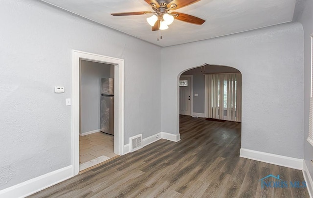 unfurnished room featuring dark hardwood / wood-style floors and ceiling fan