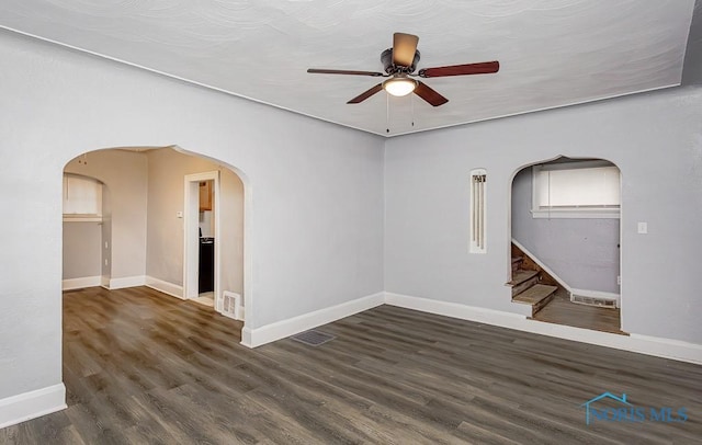 spare room featuring ceiling fan and dark wood-type flooring