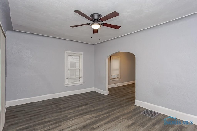 spare room with ceiling fan and dark hardwood / wood-style flooring