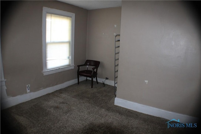 empty room featuring carpet flooring and baseboards