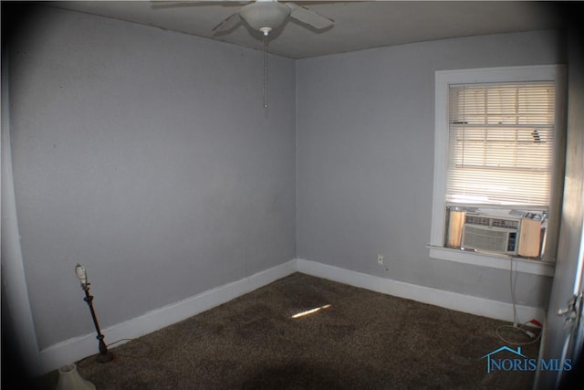 spare room with cooling unit, carpet flooring, baseboards, and a ceiling fan