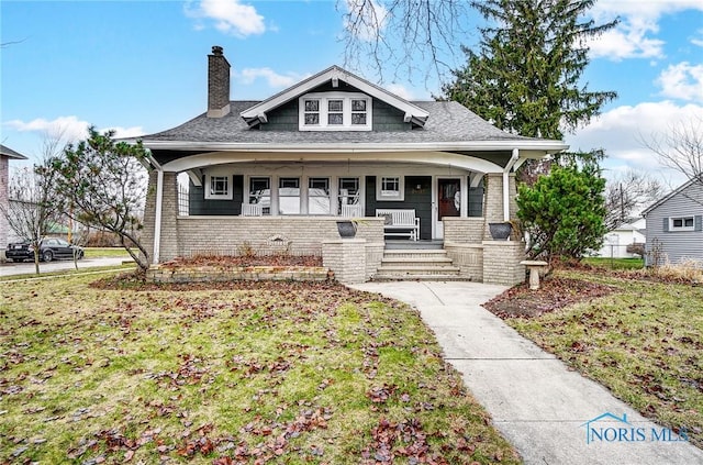 view of front of house with a front lawn and a porch