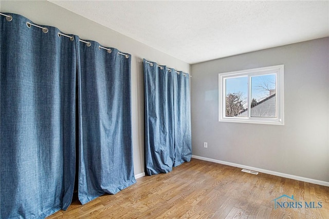 empty room featuring hardwood / wood-style flooring