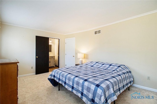 bedroom featuring ensuite bath, carpet, and ornamental molding