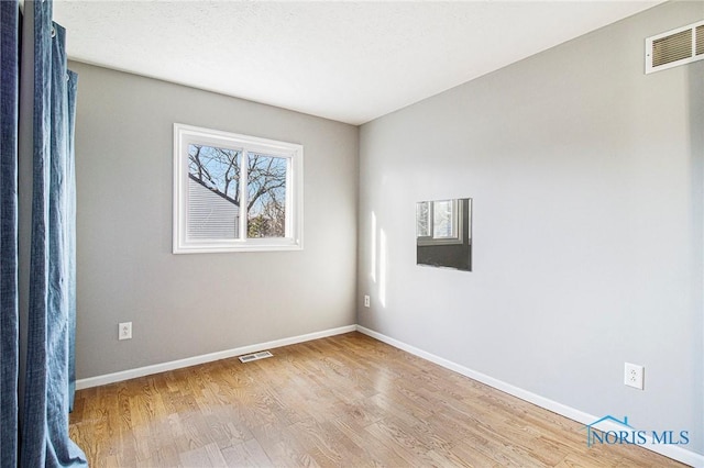 empty room featuring hardwood / wood-style floors