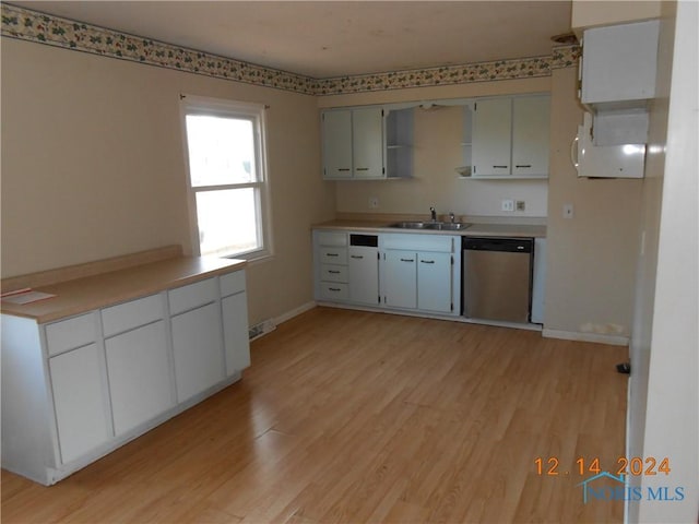 kitchen featuring sink, dishwasher, white cabinets, and light wood-type flooring