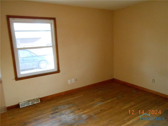 spare room with hardwood / wood-style floors and a wealth of natural light