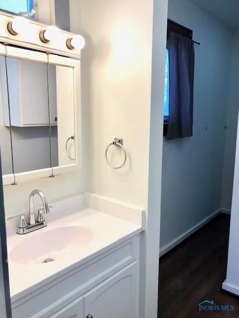 bathroom featuring hardwood / wood-style flooring and vanity