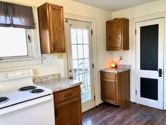 kitchen with dark hardwood / wood-style flooring and electric range