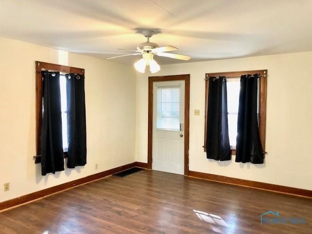 entryway featuring ceiling fan and dark wood-type flooring