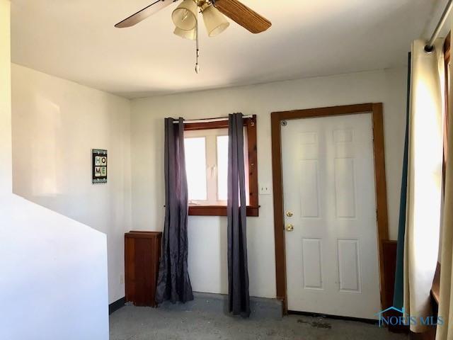 interior space featuring ceiling fan