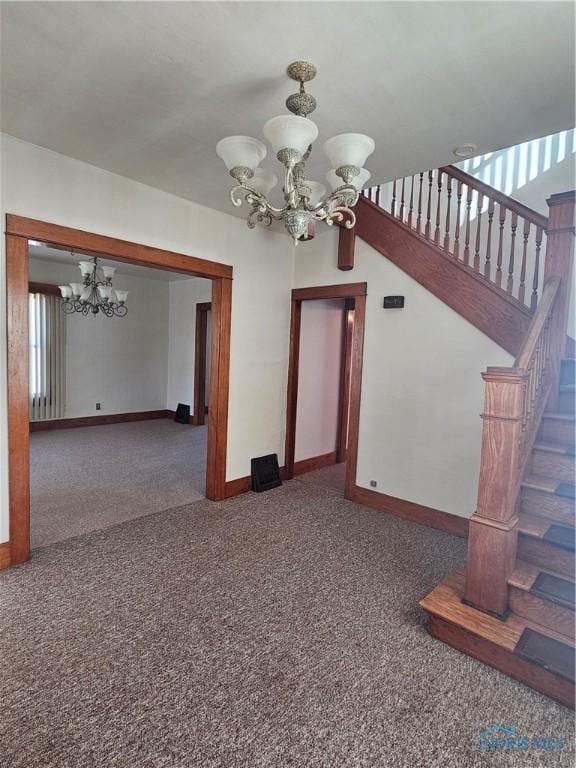 interior space with a wealth of natural light, a chandelier, and dark carpet